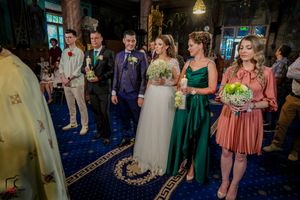 Wedding celebration in progress with guests gathered in formal attire at decorated indoor venue.