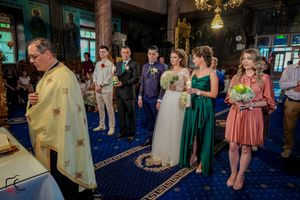 Wedding celebration in an elegant venue with blue carpet and decorative lighting.