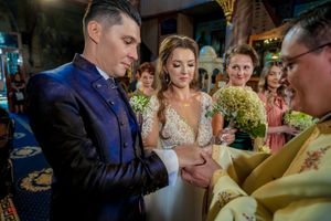 Traditional Orthodox wedding ceremony with priest performing blessing rituals.