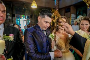 Religious wedding ceremony with priest performing blessing ritual.