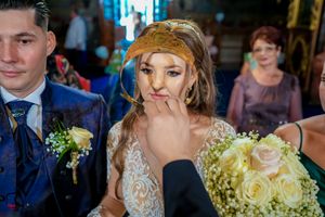 Wedding couple participates in traditional Orthodox crowning ceremony.
