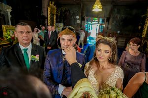 Wedding party members seated in church pews during traditional ceremony.