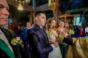 Orthodox wedding ceremony in progress with participants in formal attire.