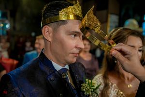 Wedding celebration in progress within an elaborately decorated Orthodox church interior.