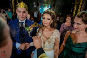 Elegant wedding celebration inside a church with decorative gold details and dim lighting.