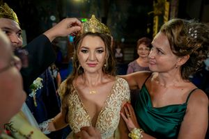 Wedding celebration with guests in formal attire and decorative lighting.