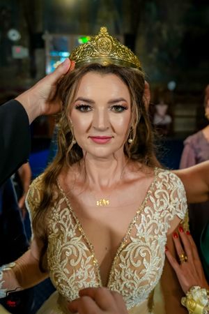 Elegant wedding reception with ornate gold crown and lace details.