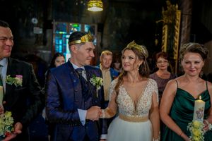 Wedding celebration with attendees in navy and emerald dresses.