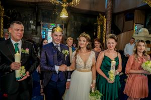 Celebration scene with guests in formal attire under warm lighting.