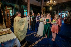 Wedding reception in luxurious venue featuring blue mood lighting and classical architectural details.
