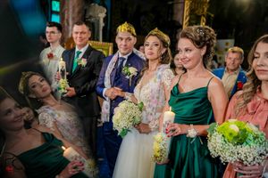 Wedding group smiles during reception while holding bouquets of baby's breath flowers.