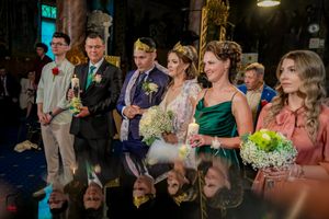 Wedding reception features dramatic lighting and elegant decor in a grand ballroom setting.