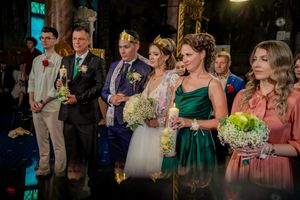 Wedding party celebrates in a beautifully lit venue with dramatic lighting effects.