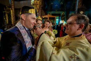 Orthodox priests in golden robes perform sacred wedding rituals at the altar.