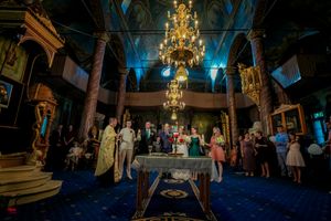 Panoramic view of a formal event space with dramatic lighting and elegant decor.