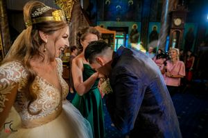 Couples dance together during an evening wedding reception with atmospheric blue lighting.