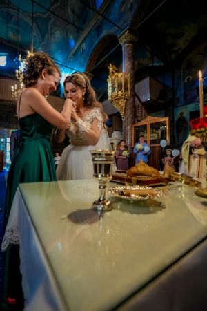 Wedding dinner setup with candles and decorations in a dimly lit venue with blue ambient lighting.