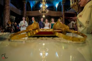 Opulent reception venue featuring dramatic lighting and classic architectural elements.