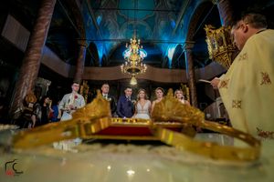 Elegant ballroom setting with dramatic blue uplighting and golden chandelier accents.
