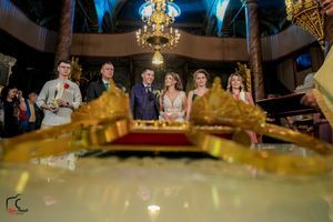 Wedding reception venue decorated with golden chandeliers and dramatic blue lighting effects.