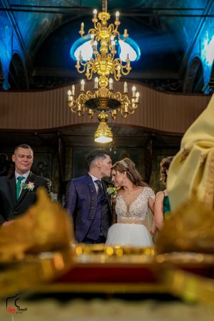 Elegant wedding venue with dramatic lighting and golden decorative elements creating a romantic ambiance.