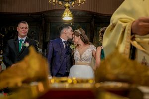 Wedding celebration in an opulent venue with dramatic lighting and golden accents.