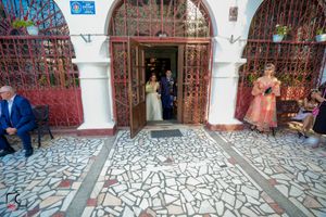 Elegant church corridor with arched doorways during a wedding celebration.