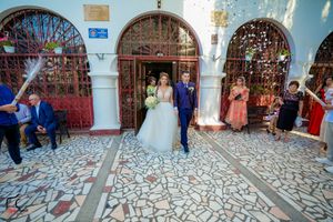 Church courtyard filled with wedding guests during a celebratory moment.