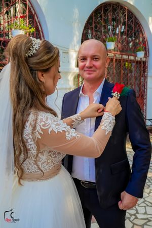 A series of candid wedding moments captured in front of a church's decorative entrance.