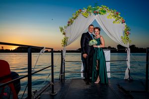 Wedding ceremony photos on dock with water views and sunset backdrop.