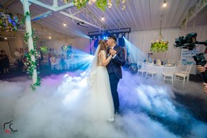 Wedding venue transformed with dramatic fog and blue lighting creating an ethereal atmosphere.