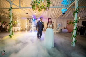 Enchanted wedding venue with fog effects and vine-wrapped pillars glowing in atmospheric lighting.