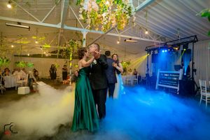 Wedding celebration features theatrical fog and blue lighting effects creating a magical atmosphere.