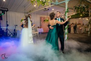 Wedding celebration features low-lying fog effects and ambient lighting creating a magical atmosphere.