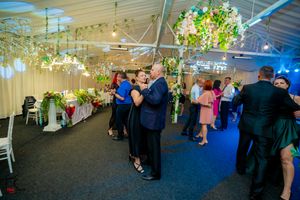 Elegant event space with suspended floral arrangements and ambient lighting creating a romantic atmosphere.
