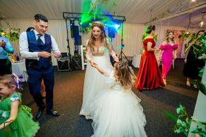 Wedding reception panorama showing dance floor activity with dramatic lighting effects.