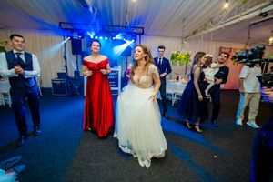 Wedding reception dance floor captured in panoramic view with dramatic blue lighting.