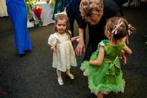 Dance floor filled with party guests in formal attire enjoying the celebration.