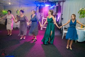 Dance floor scene at a formal event with blue and purple lighting creating a festive atmosphere.
