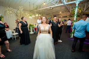 Elegant wedding reception venue with white ceiling draping and twinkling lights creating romantic ambiance.