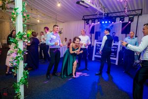 Dance floor at wedding reception lit with blue and purple lighting effects.