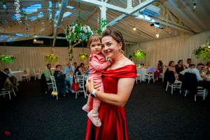 Festive gathering with guests enjoying entertainment in a decorated indoor venue space.