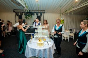Reception venue featuring modern lighting fixtures and traditional wedding decor.