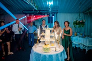 Wedding reception space with dynamic blue lighting and elegant table decorations.
