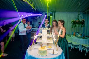 Wedding celebration space featuring dramatic lighting effects and elegant table settings.
