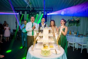 Modern wedding venue with illuminated cake display and ambient lighting creating a festive atmosphere.