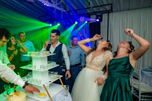 Dance floor scene with dramatic blue and green lighting effects at a formal event.