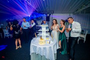 Indoor celebration space illuminated with vibrant blue and purple lighting effects.