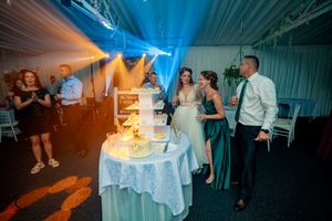 Wedding reception venue with dramatic lighting and white-clothed tables.