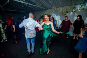 Dance party at a wedding reception with dramatic lighting and decorative elements.